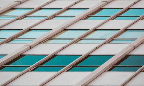 A tan building with turquoise windows